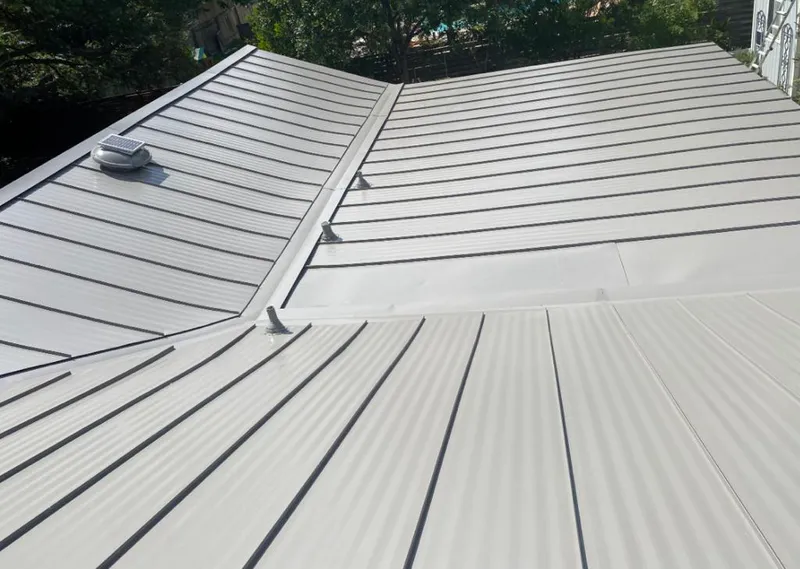 Solar attic fan installed on a metal roof for Roof Ventilation in Sandy